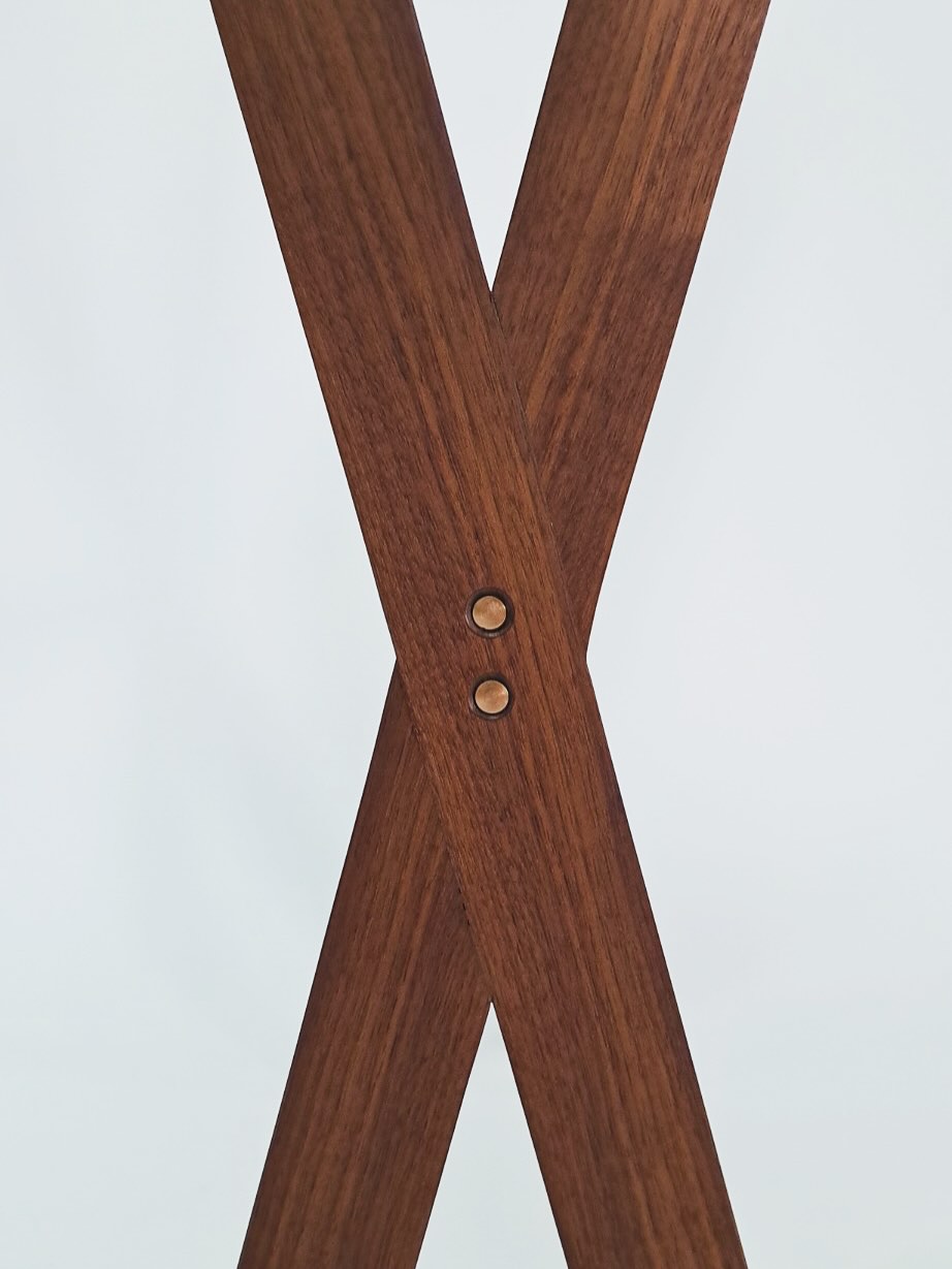 Detail of the two legs crossing, pinned together with a pair of brass rivets
